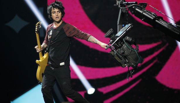 Green Day lead vocalist and guitarist Billie Joe Armstrong grabs a camera during the 2012 iHeart Radio Music Festival in Las Vegas